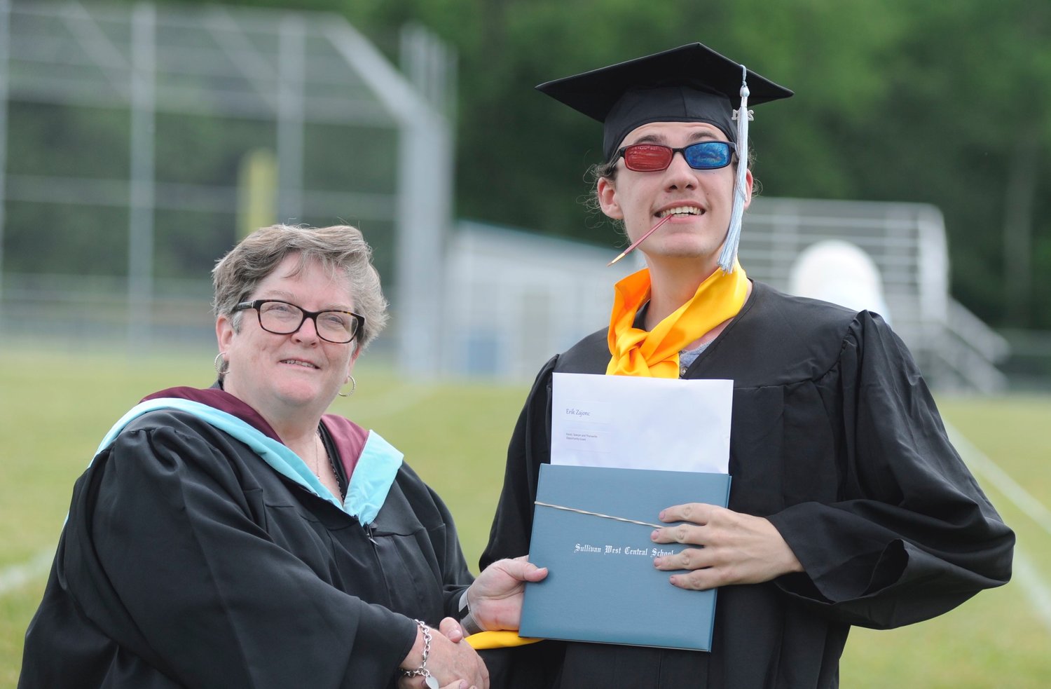 A stylish finish. Alphabetically speaking, Erik Zajonc, right, was the last senior to receive his diploma. But the self-described “aspiring artist” showed a bit of colorful artistic flair as he was awarded his sheepskin by board of education president Rose Joyce-Turner.